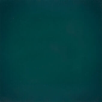Dark teal chalkboard texture with a matte finish, displaying subtle tonal variations and light speckles across a slightly worn, uneven surface.
